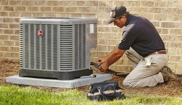 Person installing an AC unit with equipment