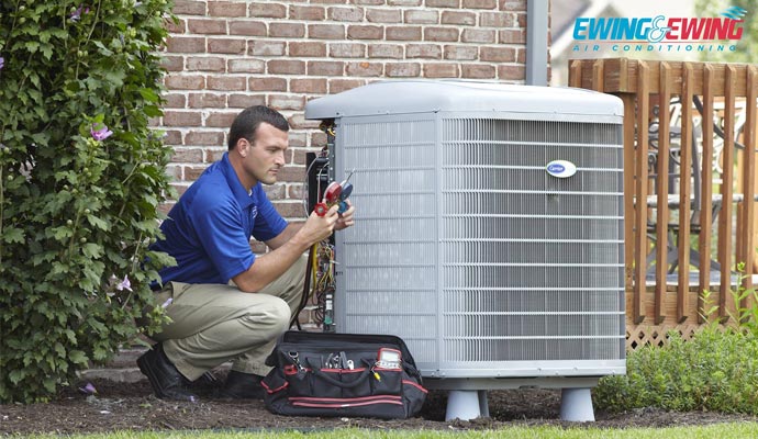 a man performing ac unit maintenance service