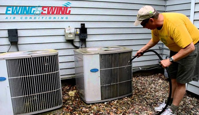 a man cleaning a dirty ac