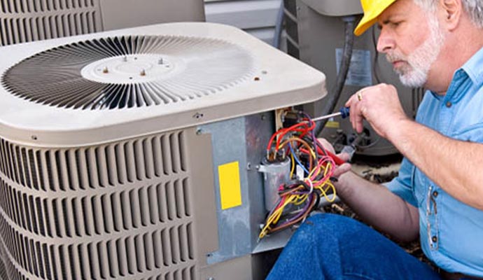 A person repairing the AC with equipment