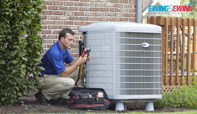 Person servicing an air conditioning unit