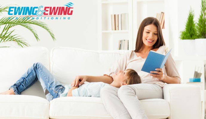 woman and a boy sitting on a sofa in a living room