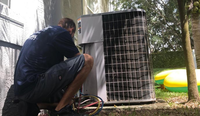 Worker maintaining the heat pump