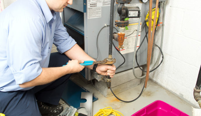 professional worker repairing a heater