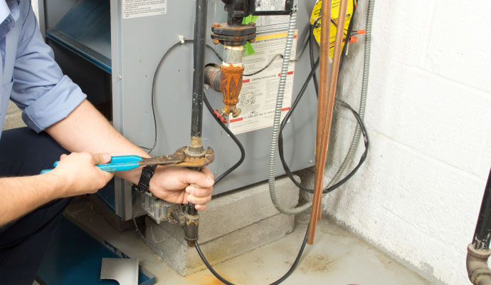 a professional technician performing maintenance on a heating system