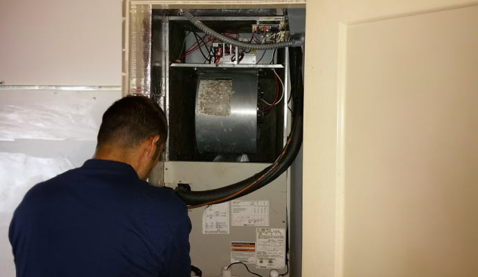 Technician working on heater maintenance