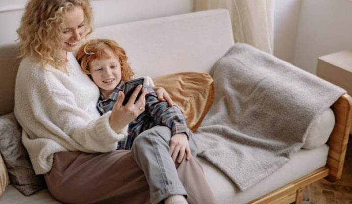 A woman and her child relaxing in room