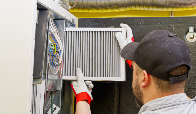 professional worker replacing HVAC filter