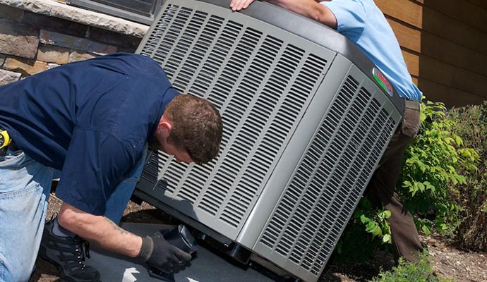 professional worker installing HVAC outdoor unit