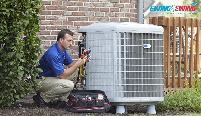 Person repairing HVAC system with equipment