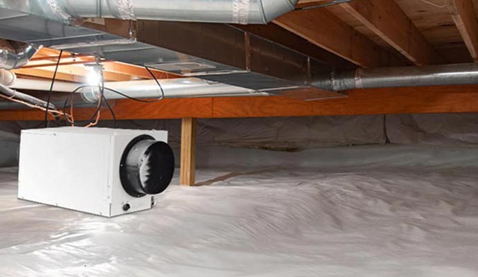 Installed dehumidifier in wooden crawlspace.