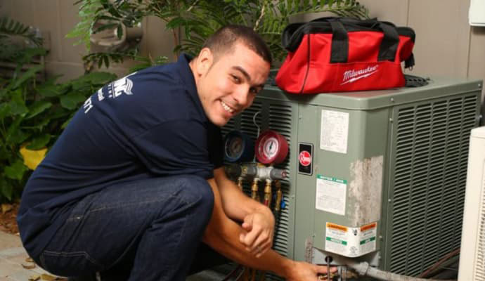 professional worker repairing outdoor AC unit