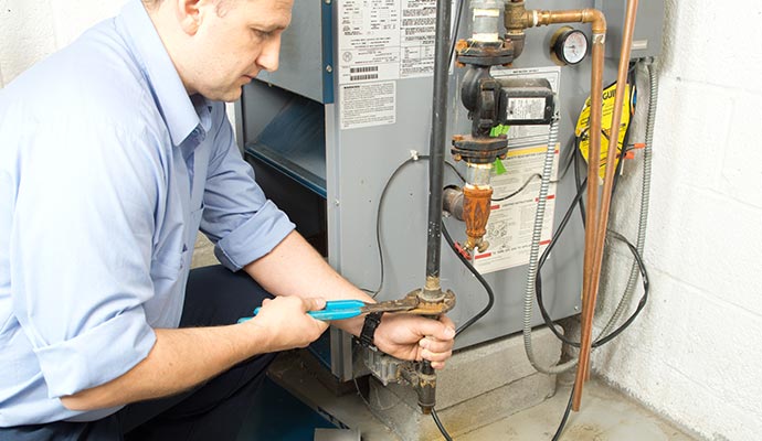 Person repairing heater system with equipment