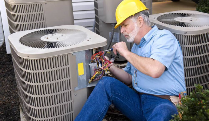 Professional repairing a HVAC system using equipment