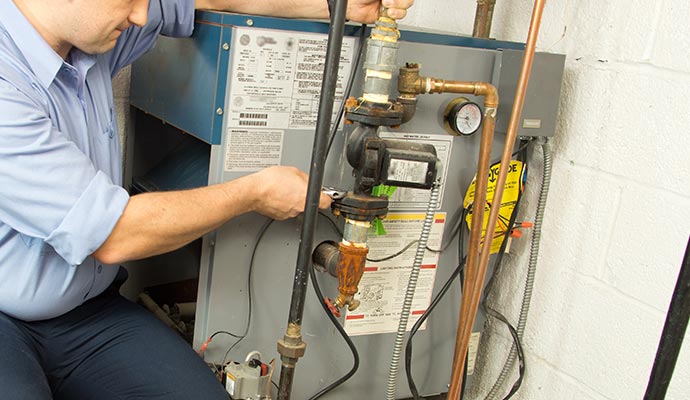 Technician servicing a gas furnace